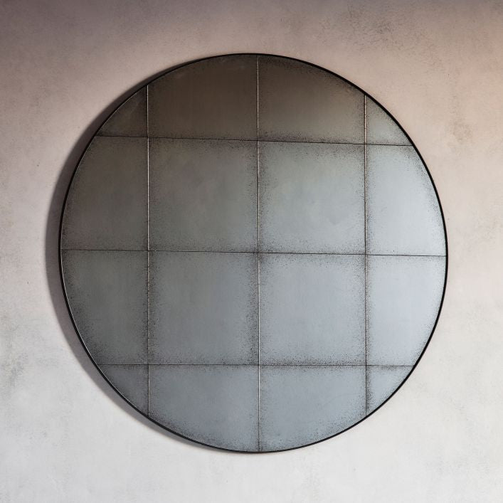 Baxter medium antiqued round wall mirror with grid detail in a structural metal outer frame | malletandplane.com