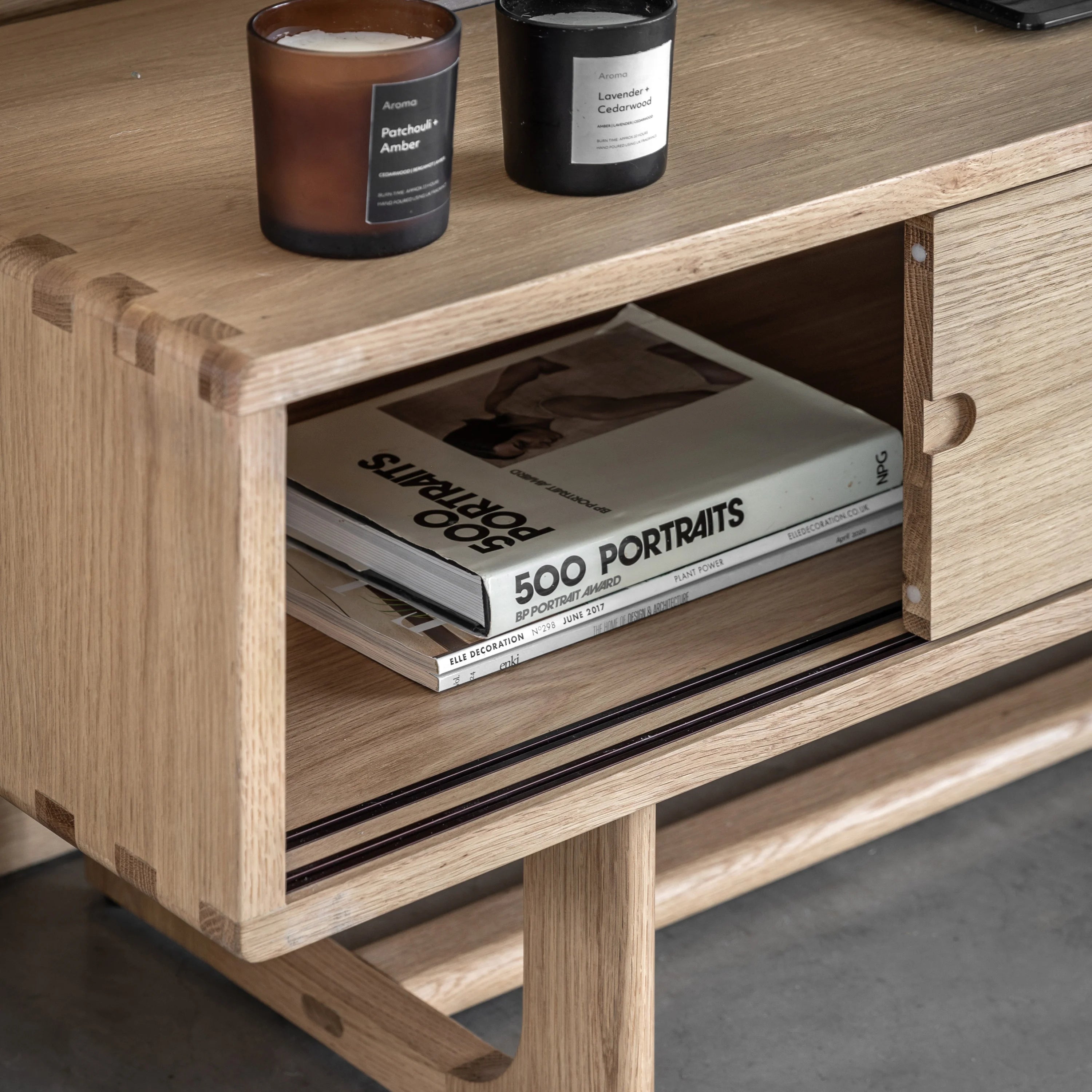 Kantu oak media unit with sliding doors and shaped underframe in natural finish