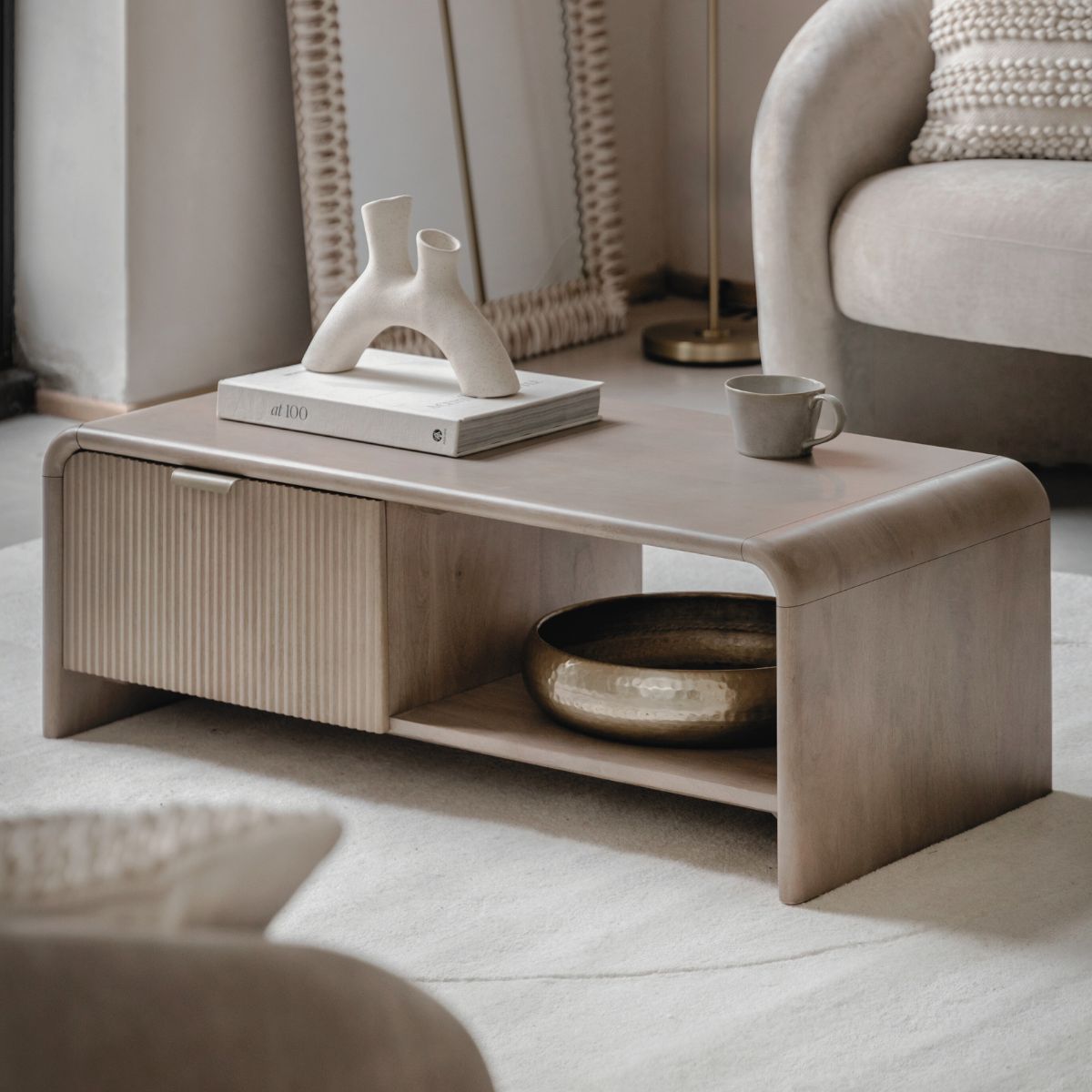 Rocca mango coffee table with curved edges, fluted drawer front and brushed brass hardware | malletandplane.com