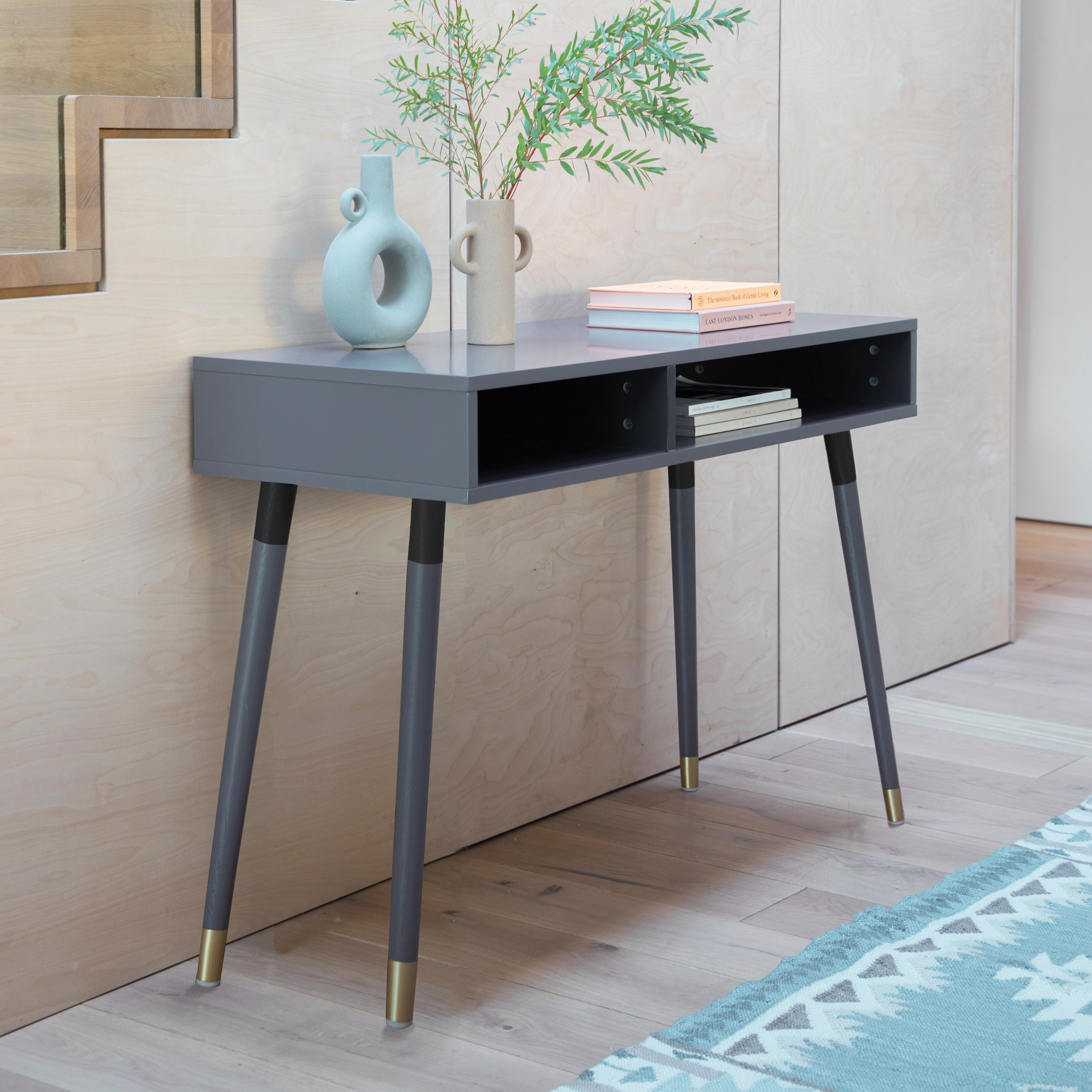 Evissa grey console table with brass socks and adjustable feet | malletandplane.com