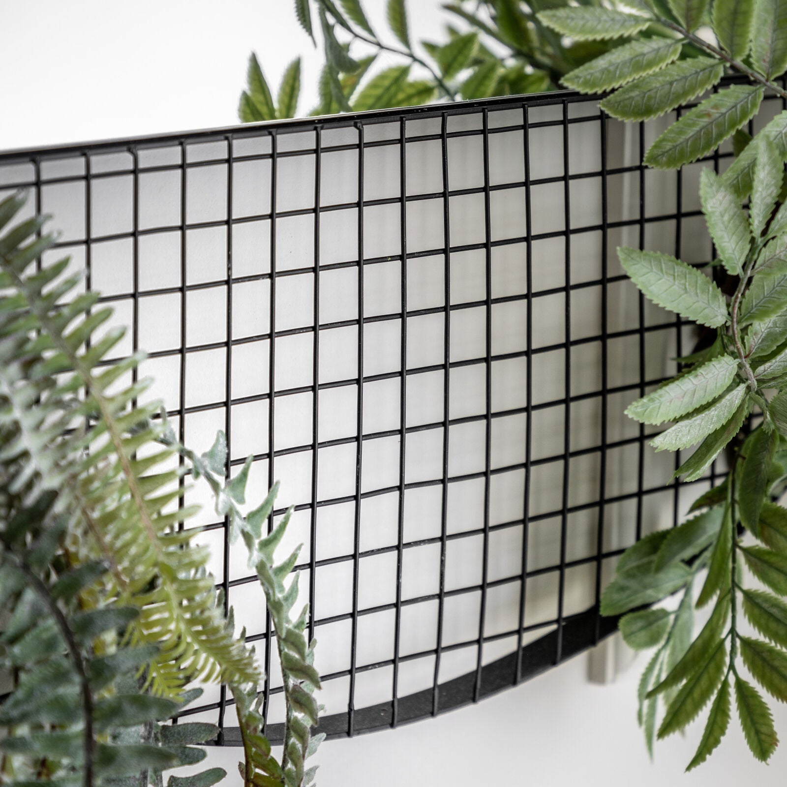 Grid metal round wall mirror with grid storage section | malletandplane.com