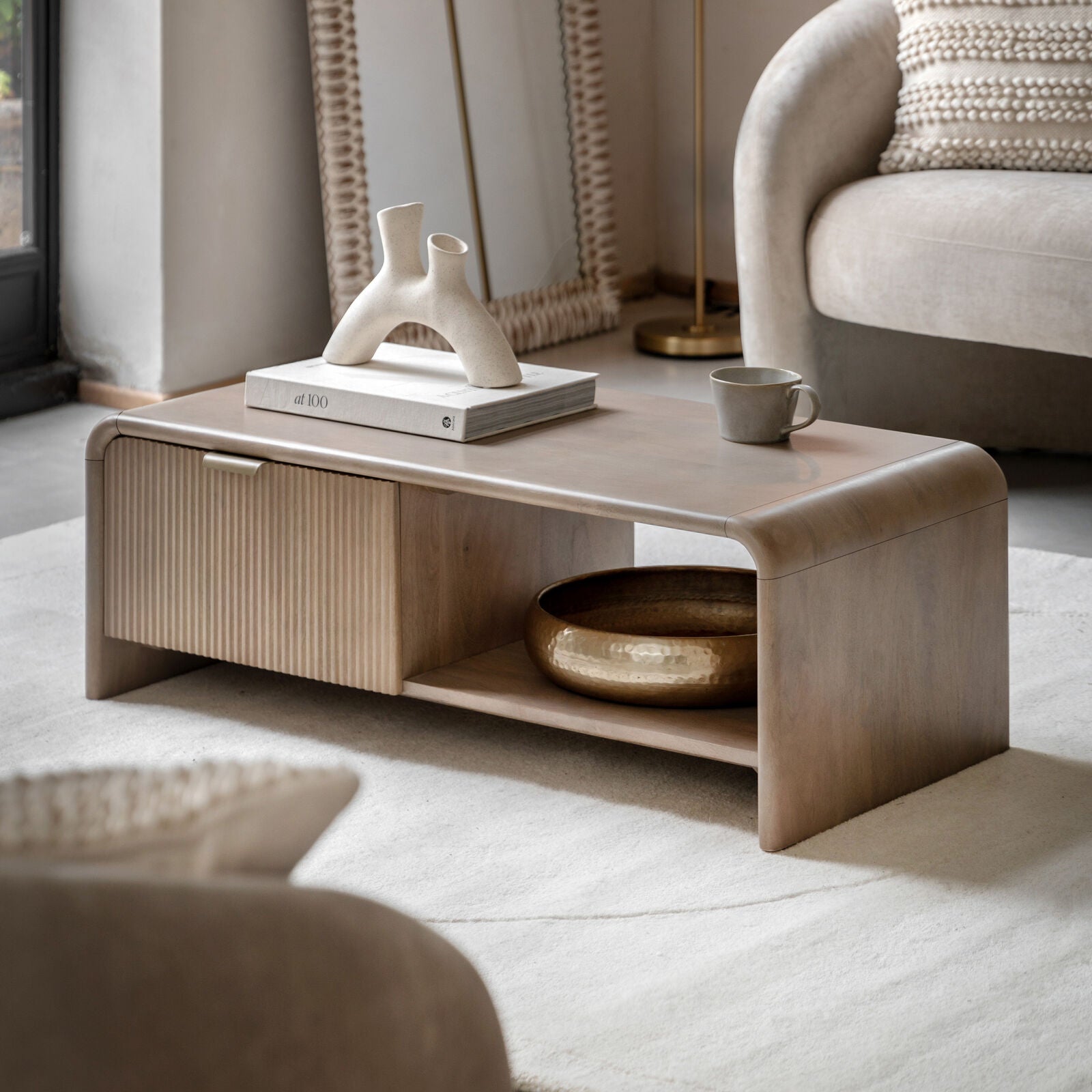 Rocca mango coffee table with curved edges, fluted drawer front and brushed brass hardware | malletandplane.com