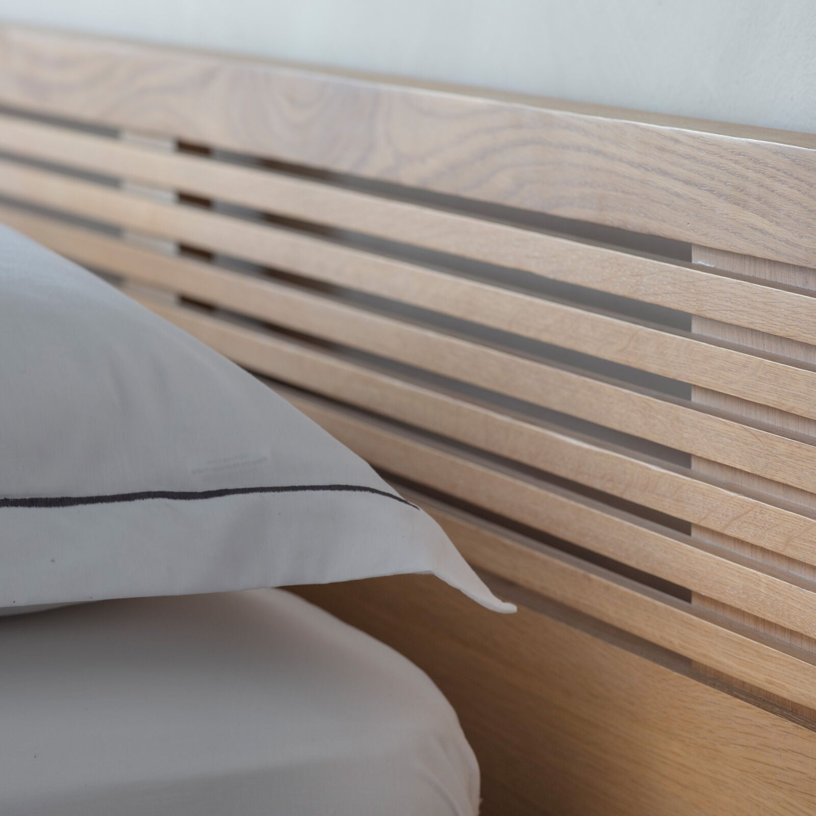 Soja king size bed with radius slats in natural oak finish with black metal legs | malletandplane.com
