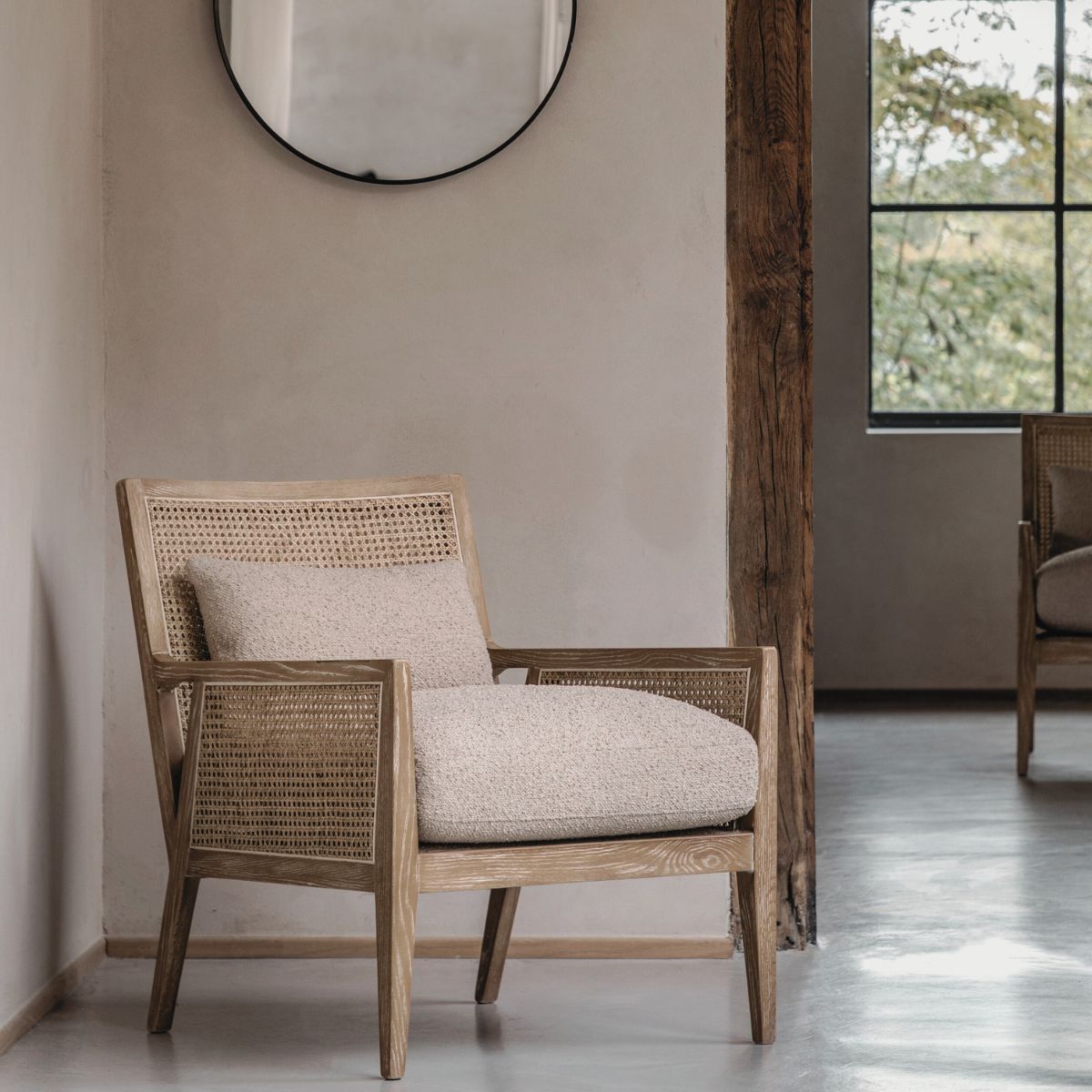 Osaka natural rattan armchair with solid wood frame, woven rattan backrest and cream upholstered seat — a stylish Scandinavian accent chair for living rooms or bedrooms